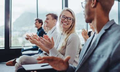 Audience applauding speaker after conference presentation